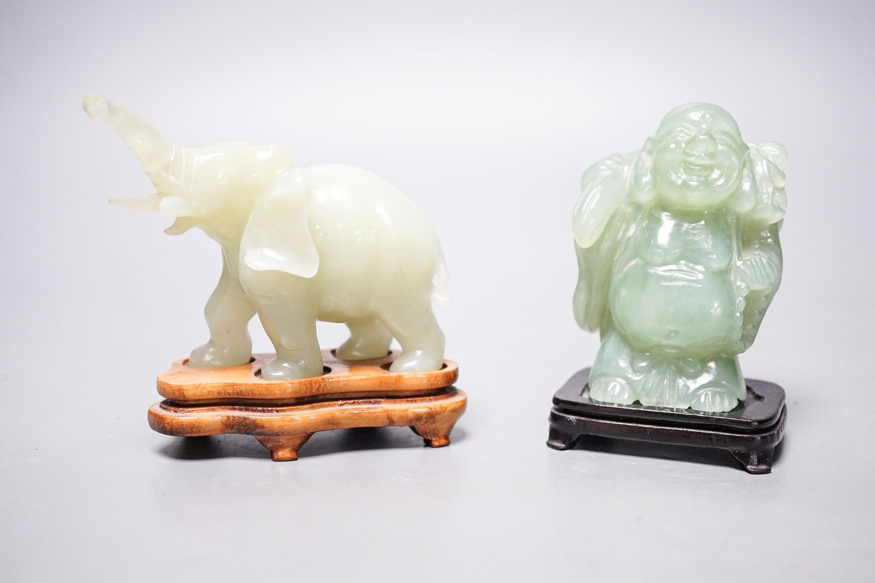 Two bowenite carvings of an elephant and Budai, wood stands, tallest, 9.5cm